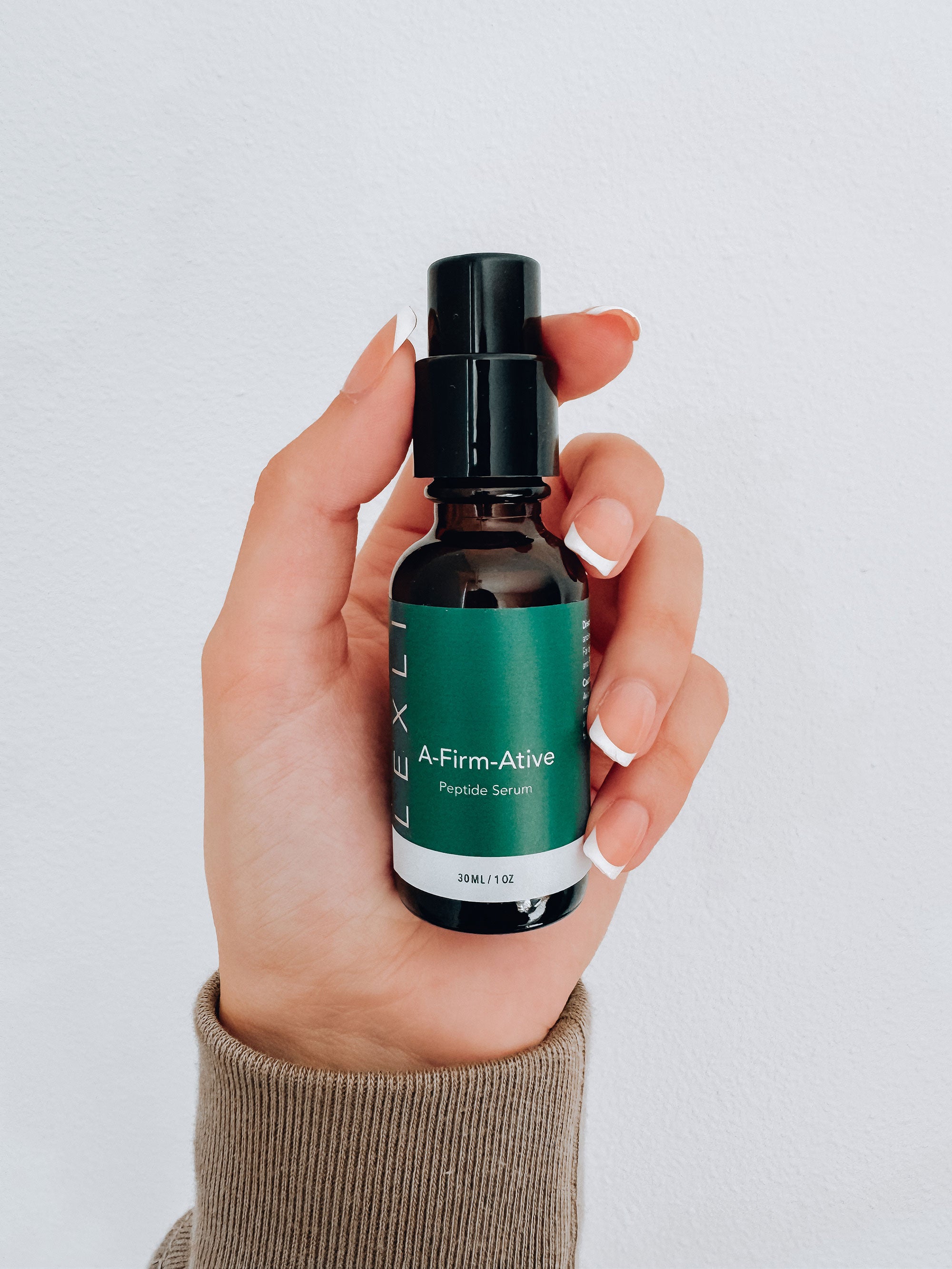 hand holding bottle of A-Firm-Ative