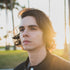 young man standing outside with a jacket