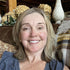 woman relaxing on her couch and smiling