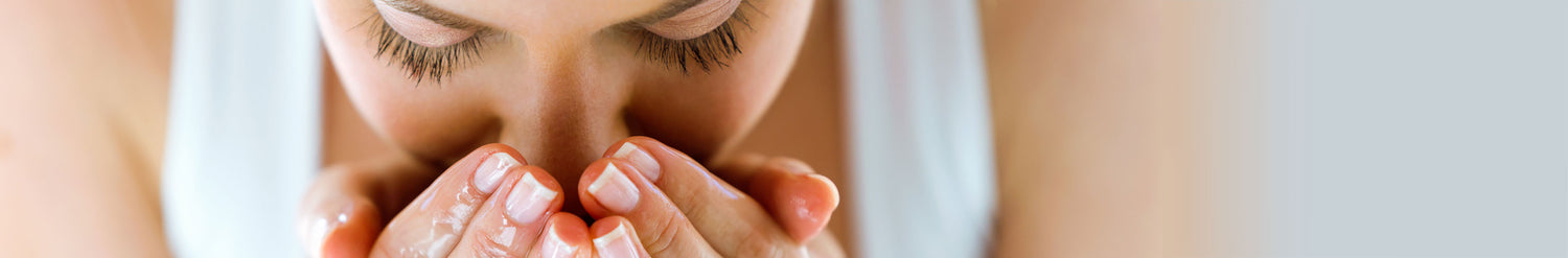 woman splashing water on her face