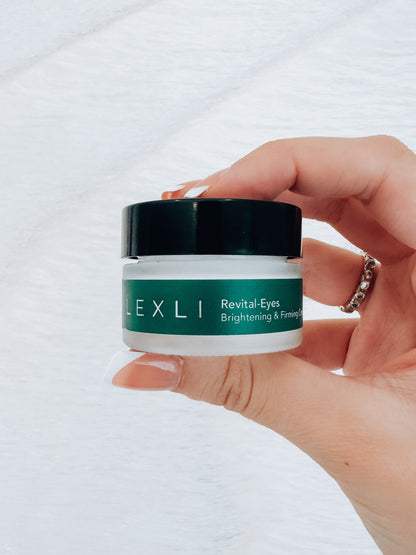 Photo of hand holding a .5 ounce jar of Lexli Revital-Eyes brightening and firming eye cream.